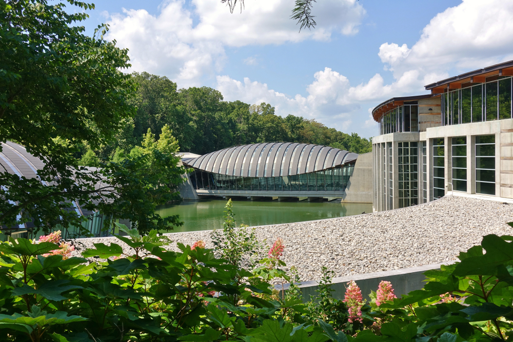 Crystal Bridges Museum with blue sky and brown and silver building one of the best things to do in Arkansas 