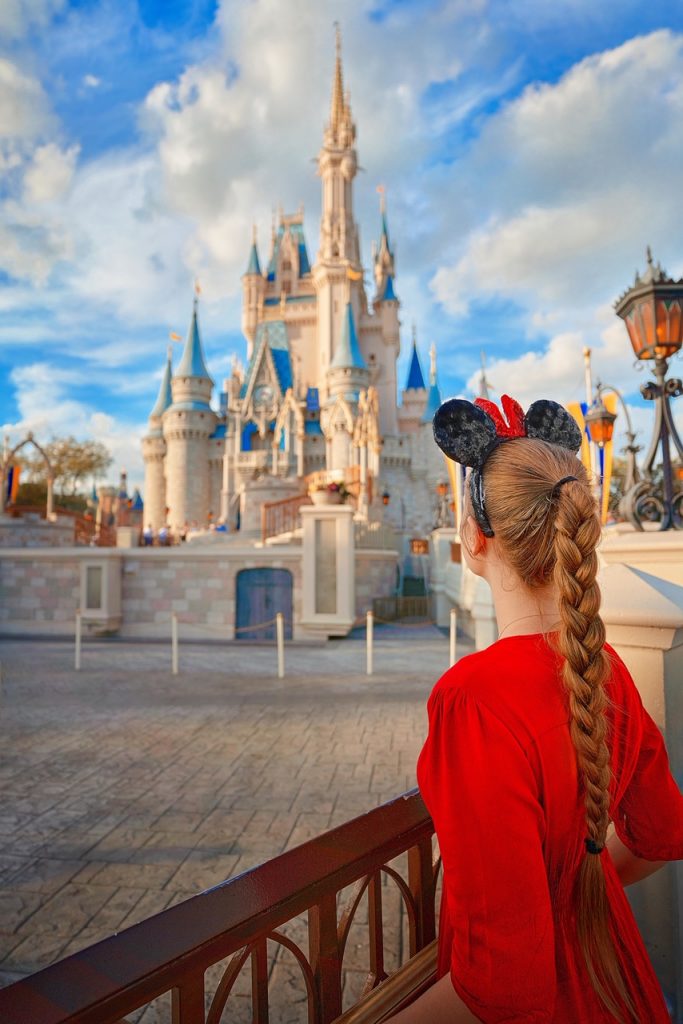 Photo of young woman looking at Cinderella's Castle in Disney World. 