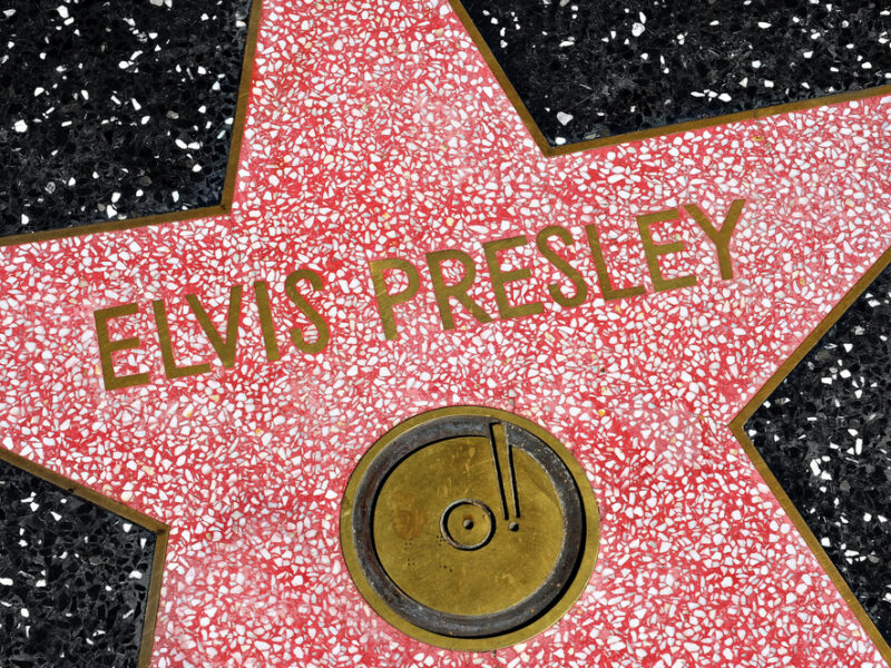 A close up of Elvis' Hollywood Star of Fame, a red star on black tile with his name spelled out across it.