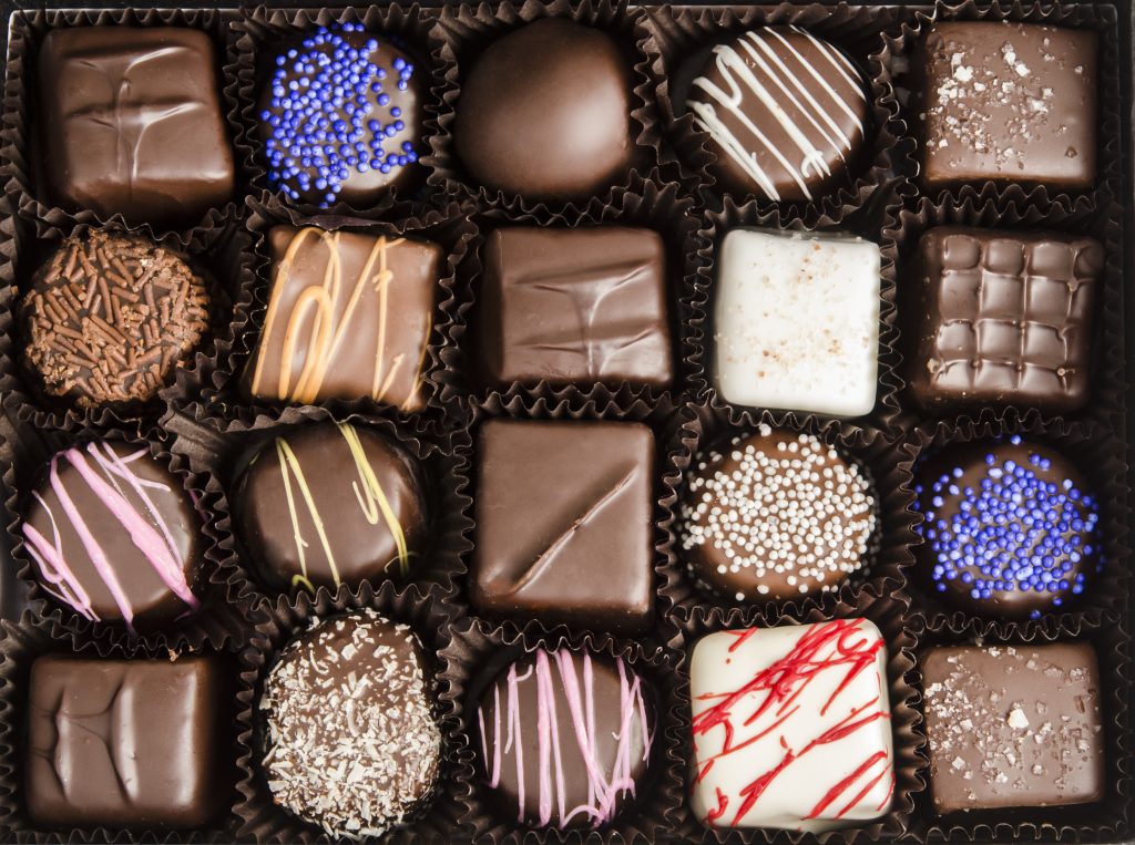 Photo of a decadent box of assorted chocolates.