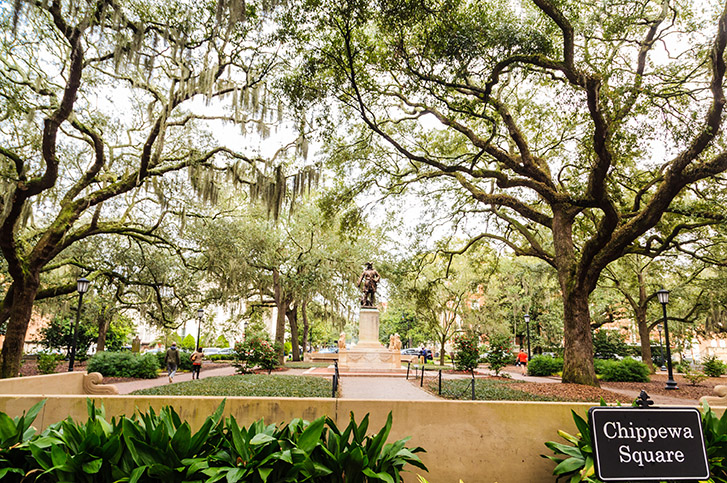 Moss-covered oaks surround a statue in Chippewa Square in Savannah, where some of the film Forest Gump was filmed.
