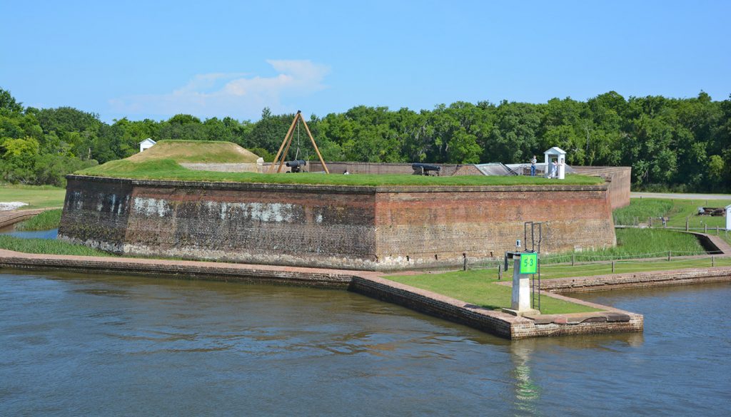 The grass-covered brick walls of Old Fort Jackson, which sits along the water, one of the most popular things to do in Savannah.