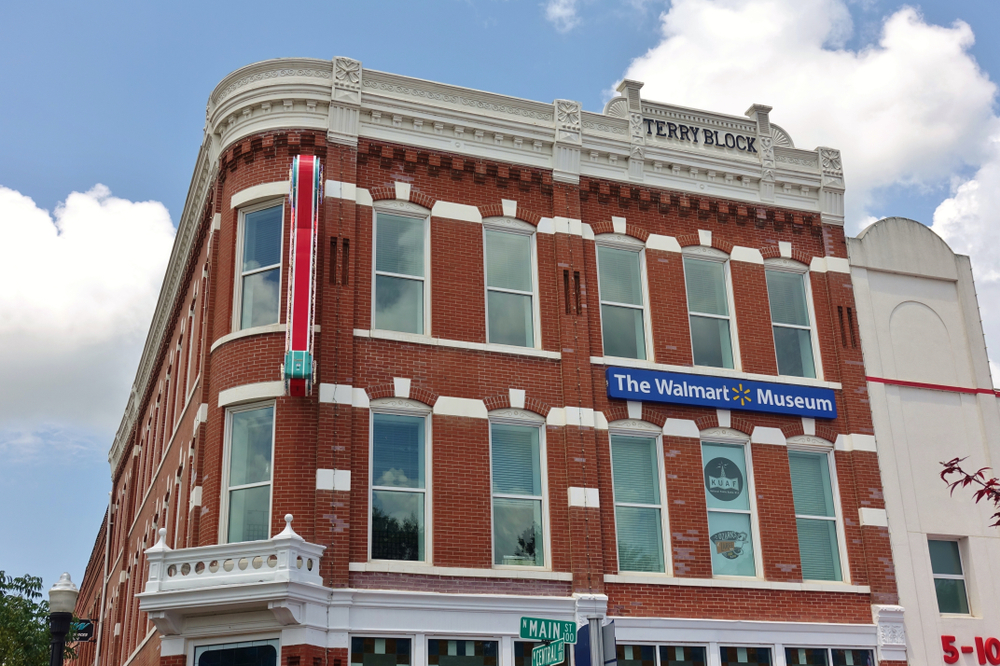 The exterior of the Walmart Museum which is a red building with white trim and one of the best things to do in Arkansas