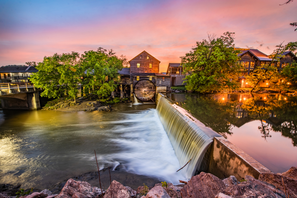 old buildings lining a small river in Pigeon Forge