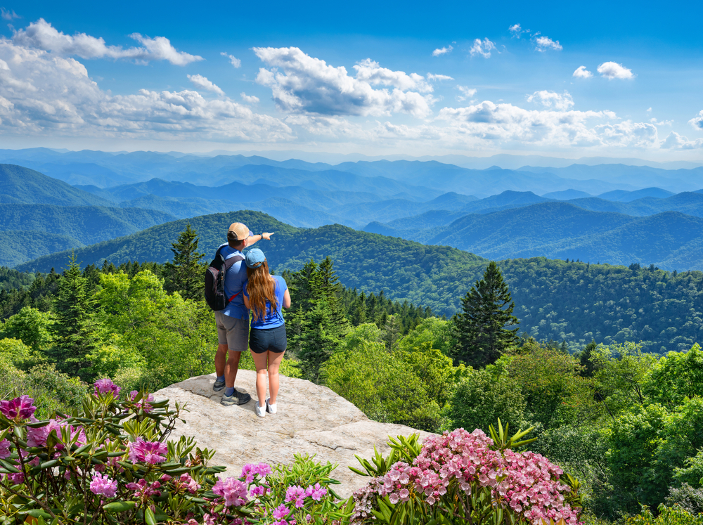 A couple looking out at the mountains of Pisgah National Forest near Asheville North Carolina one of the most romantic getaways in the South