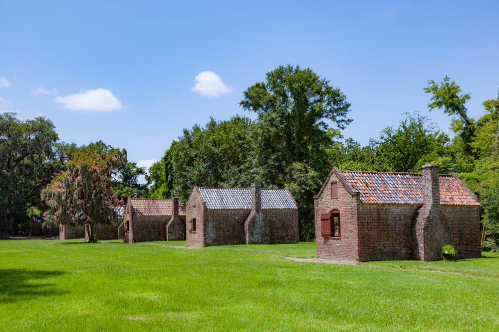 The slave quarters at the Boone Hall Plantation on a sunny day on a grassy field one of the best south carolina road trips