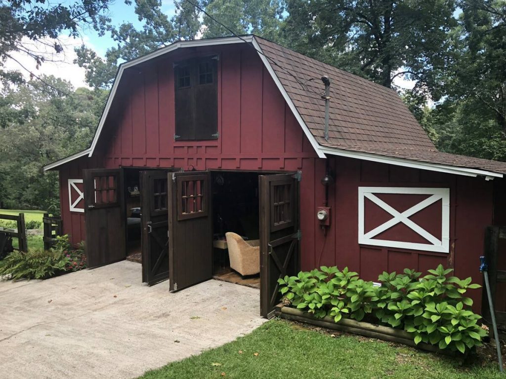 classic red peaked roof barn that you can stay in in Alabama 