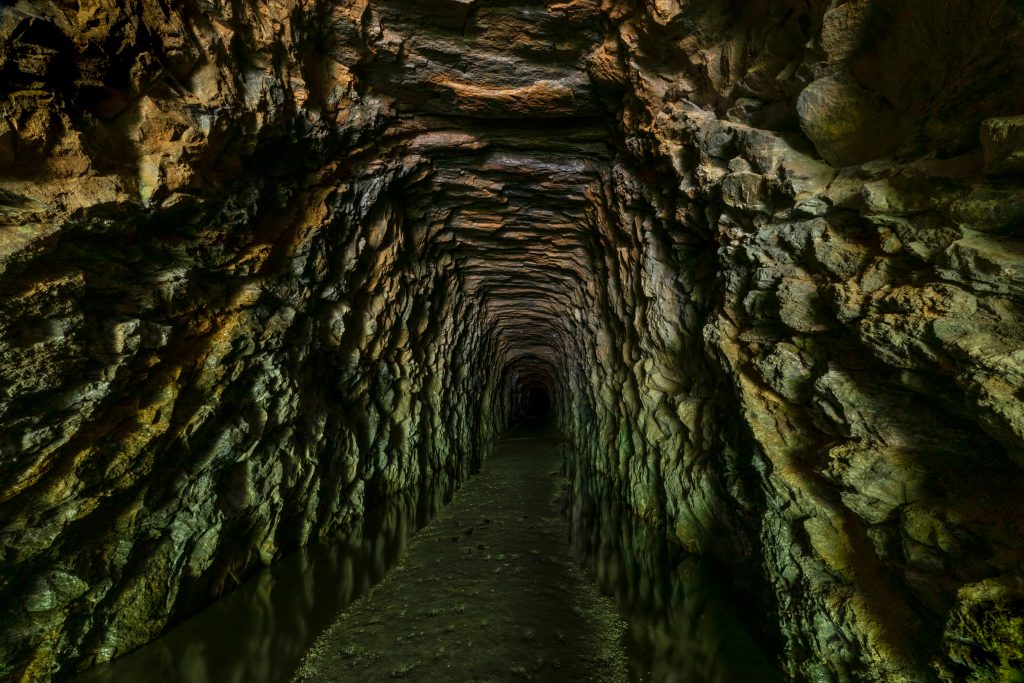 A camera peers down the shaft of the Stumphouse Tunnel, one of the best hidden gems in South Carolina.