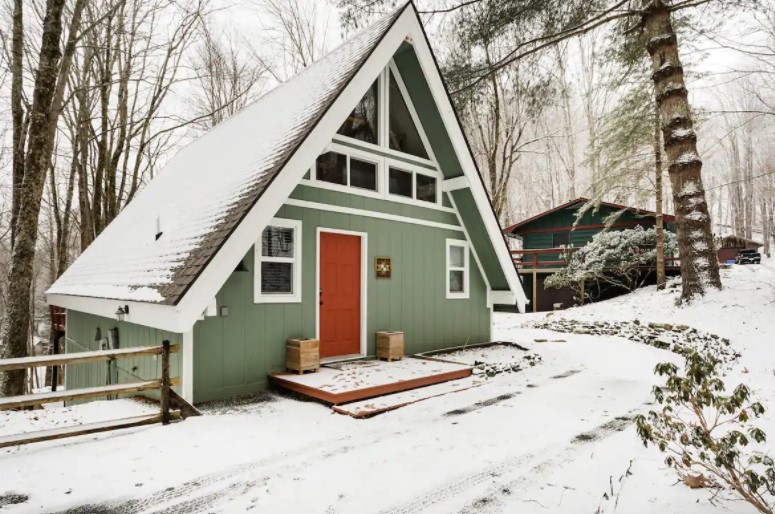 A cute A-frame cabin covered in snow in North Carolina one of the coziest cabins in the South