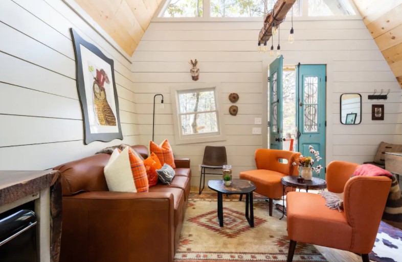 The inside of a charming cabin with purposefully wonky features.