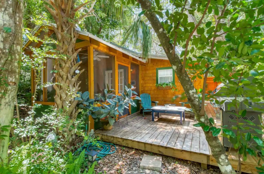 The view of the secluded front porch of a cabin surrounded by Florida wildlife