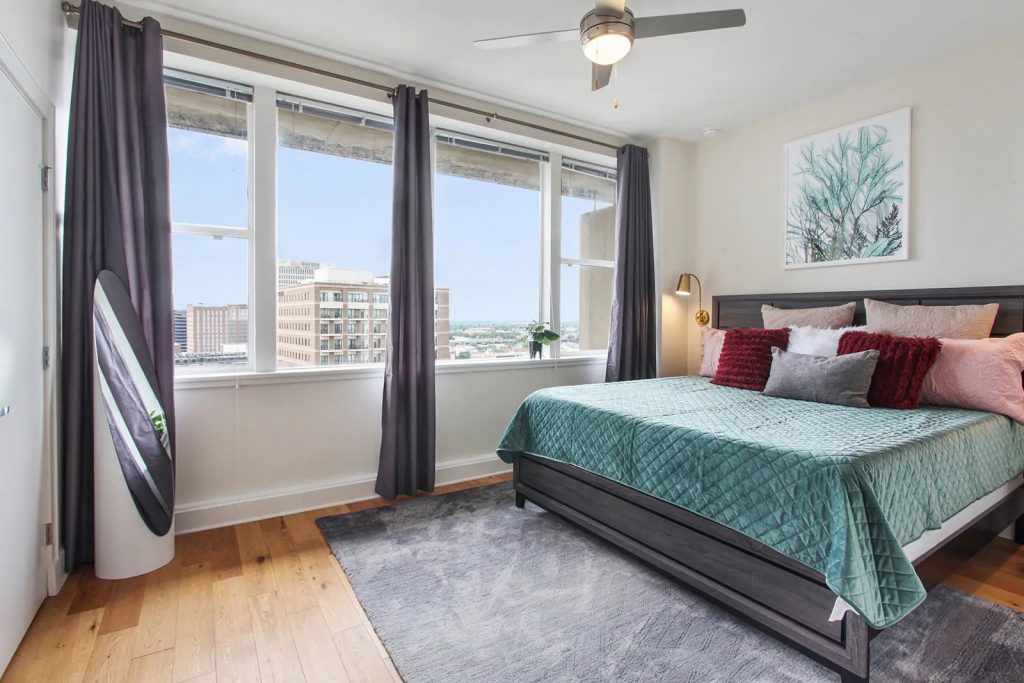 Photo of a penthouse Airbnb in New Orleans with city views from the bedroom.