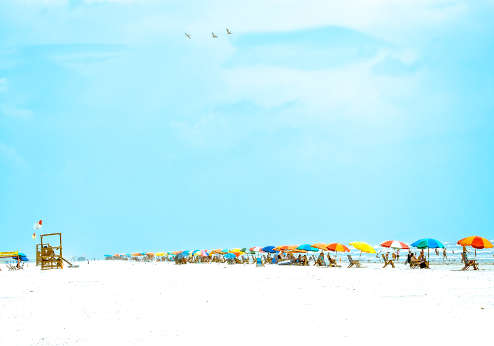 A photo of a row of colorful umbrellas along Stewart Beach. One of the prettiest beach in Texas.