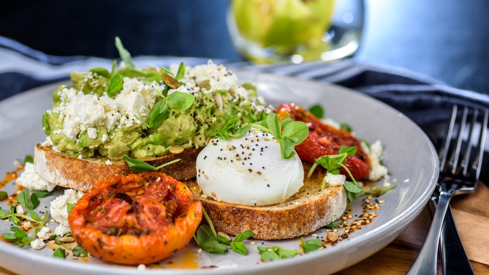 Photo of avocado toast topped with poached eggs, a tasty option for the best breakfast in Savannah