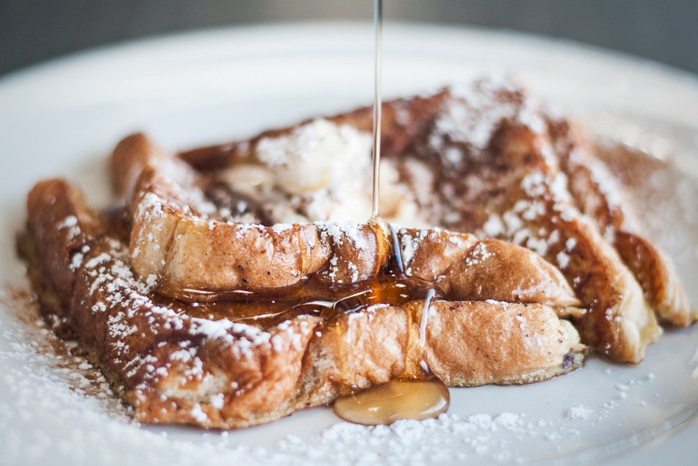 Photo of french toast topped with powdered sugar and male syrup, a classic and delicious option for breakfast in Savannah