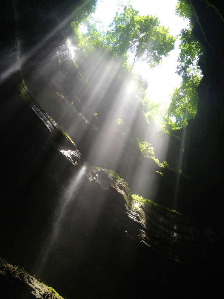 Looking up at the sunlight from the bottom of Neversink Pit
