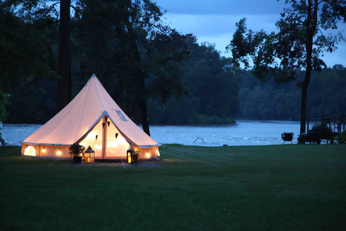 Photo of a riverfront yurt that is one of the best glamping in Georgia Airbnbs. 
