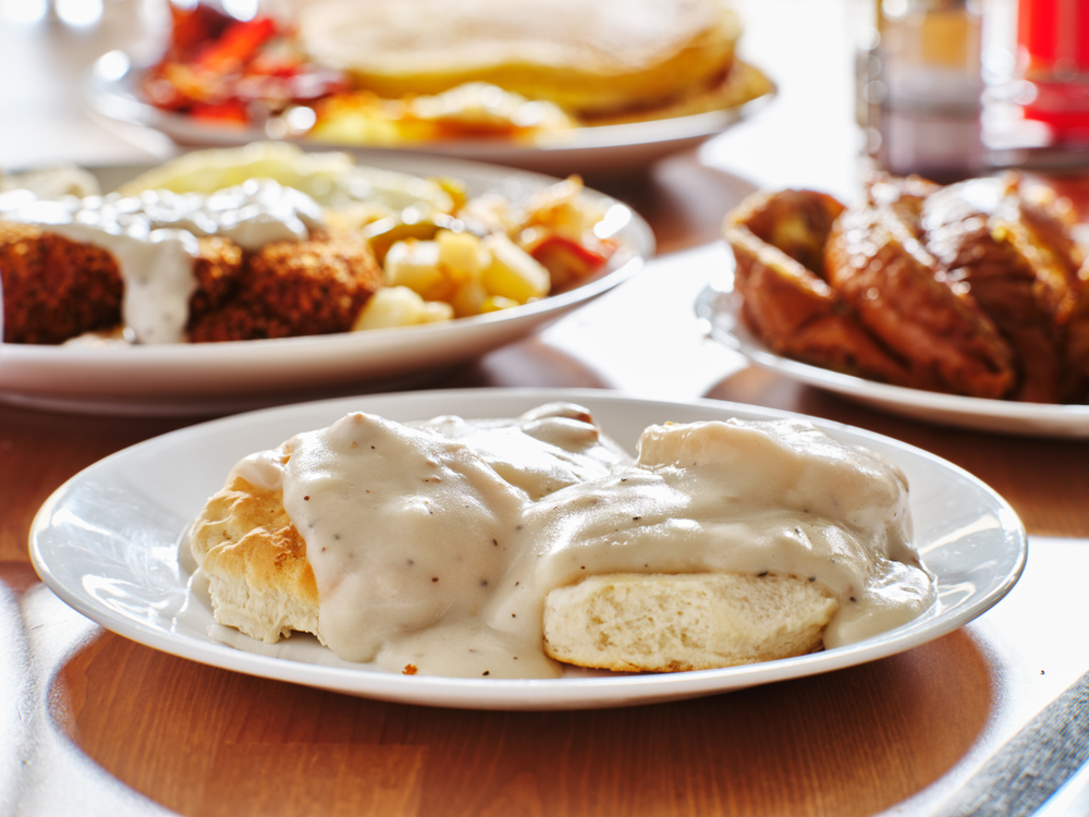 Photo of biscuits and gravy, chicken fried steak, and pancakes which are all southern breakfast staples you can find at restaurants in Savannah.