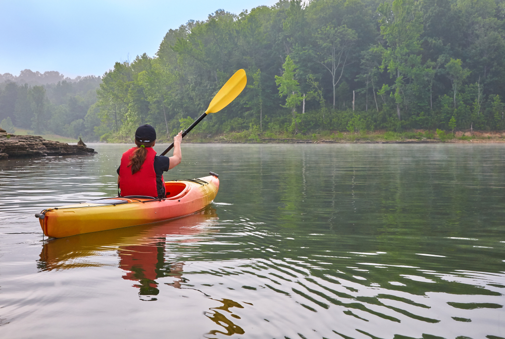 Photo of a woman exploring Barren River Lake in a kayak.