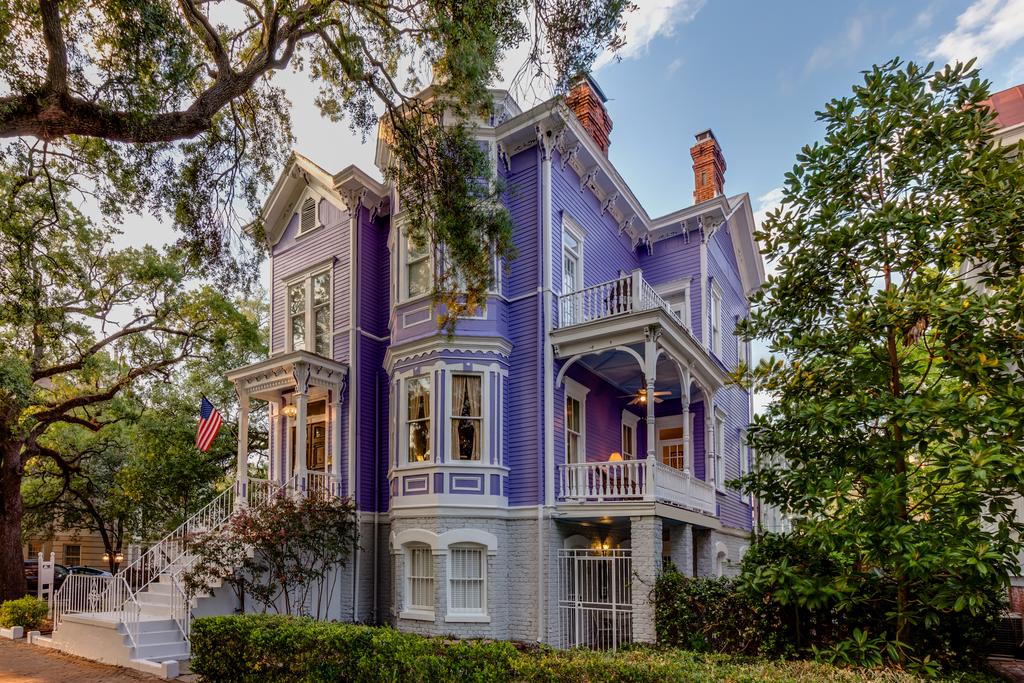 A purple Victorian style home with white windows in an article about bed and breakfast in savannah
