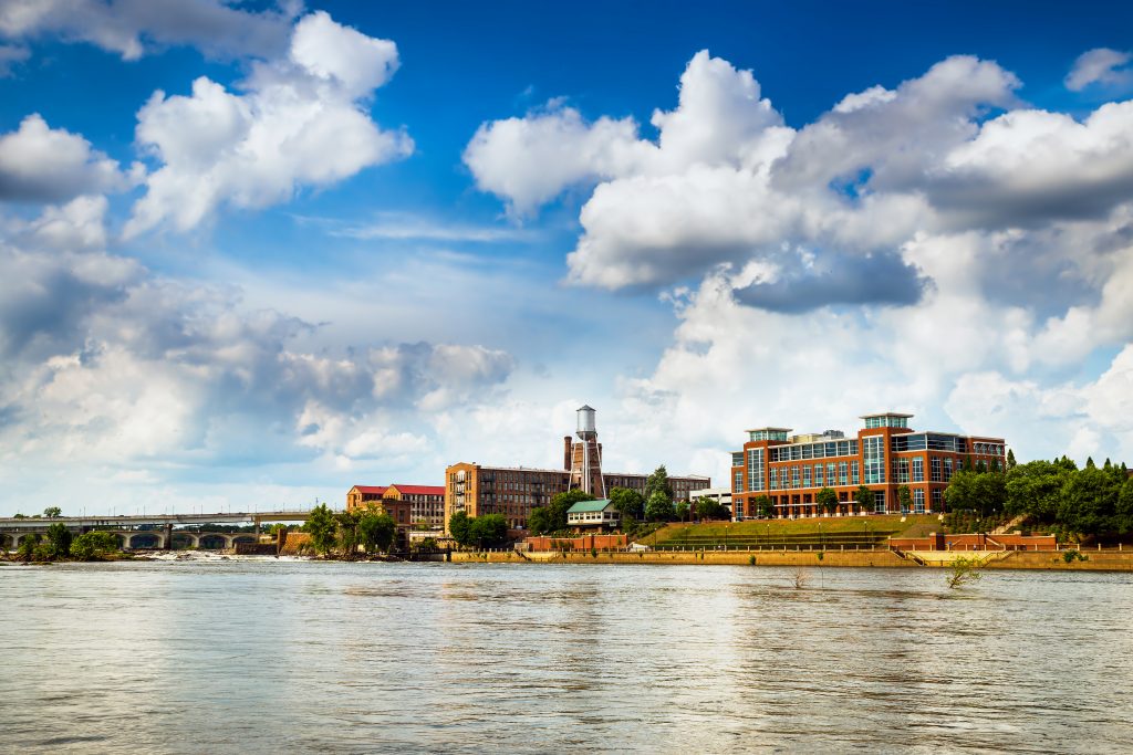 Photo of Columbus, Georgia's Riverwalk, featuring the 14th street Pedestrian Bridge in the distance.