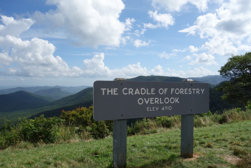 A sign shows the cradle of forestry overlook, showing the hills and mountains of North Carolina.