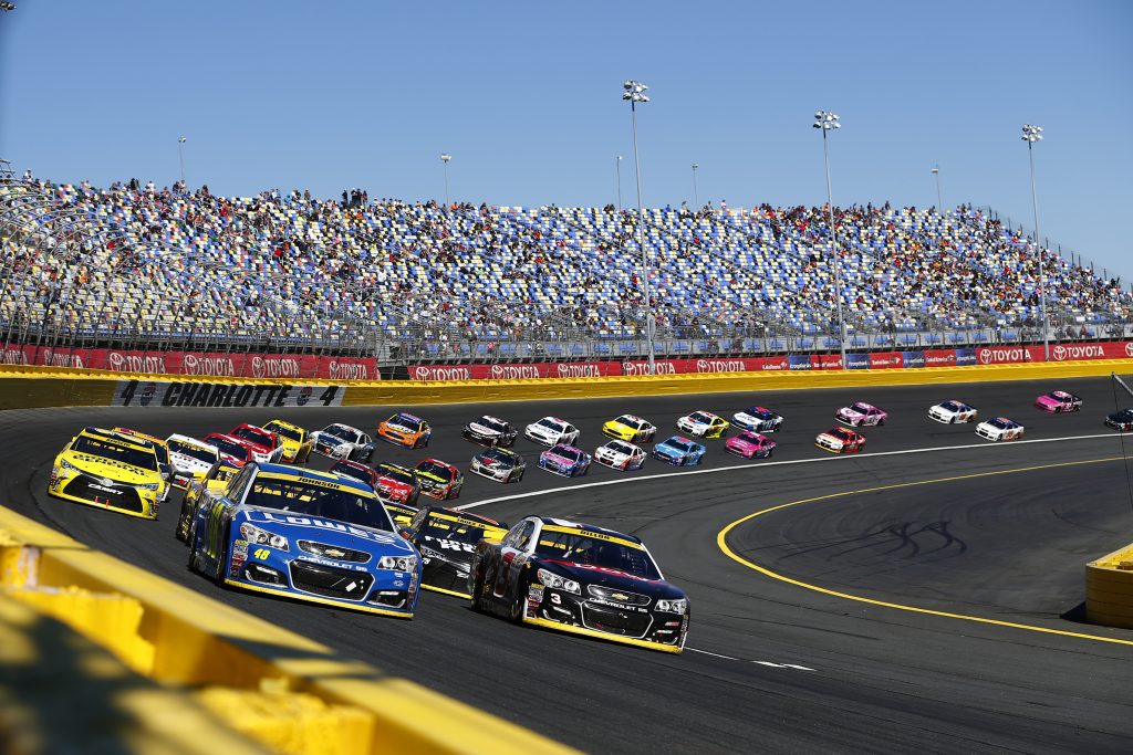 Cars speed along the Charlotte Motor Speedway on a NASCAR North Carolina road trip.