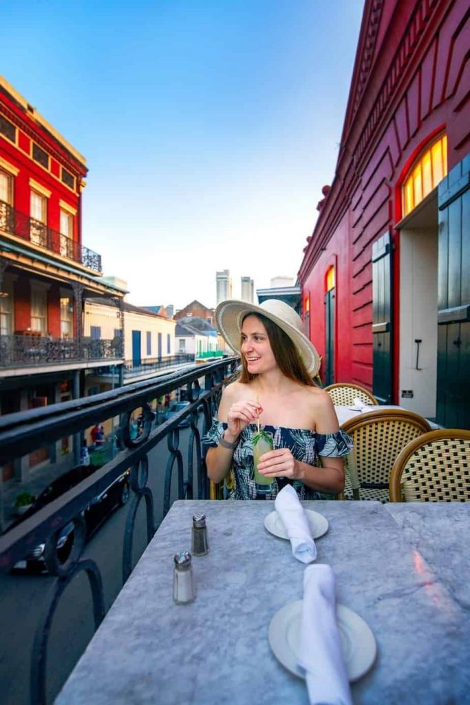A woman dining on a balcony in the French Quarter in New Orleans
