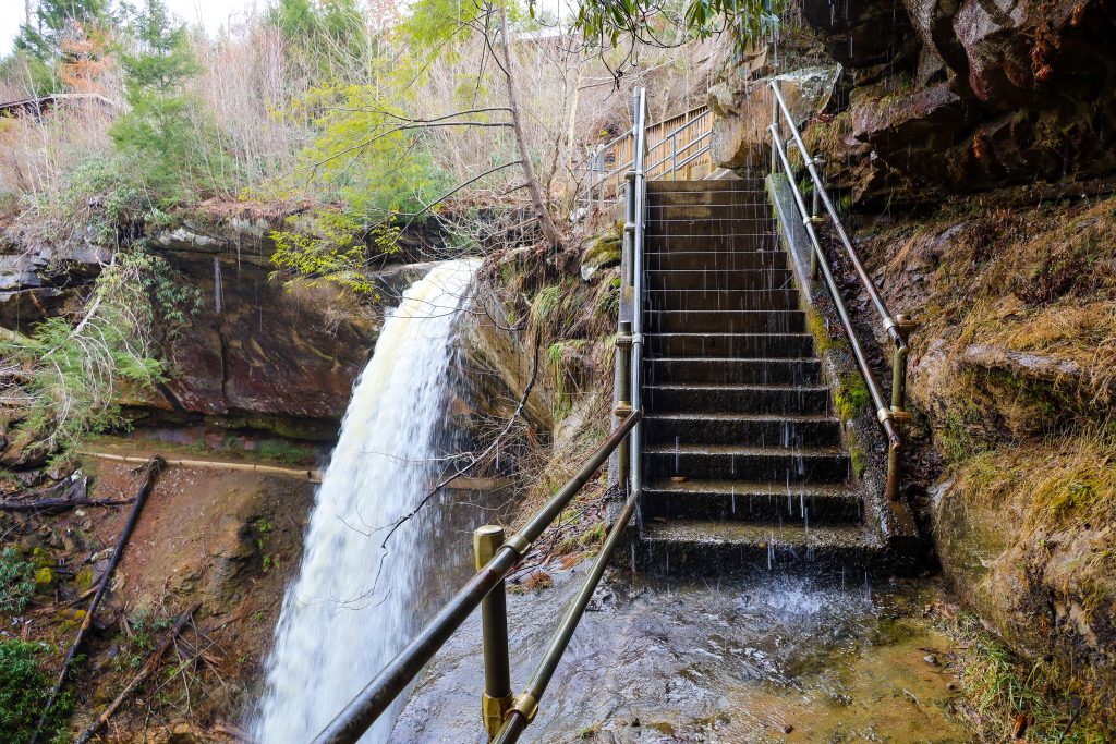 The stairs from the trail wind down and around Broke Leg Falls in Kentucky.