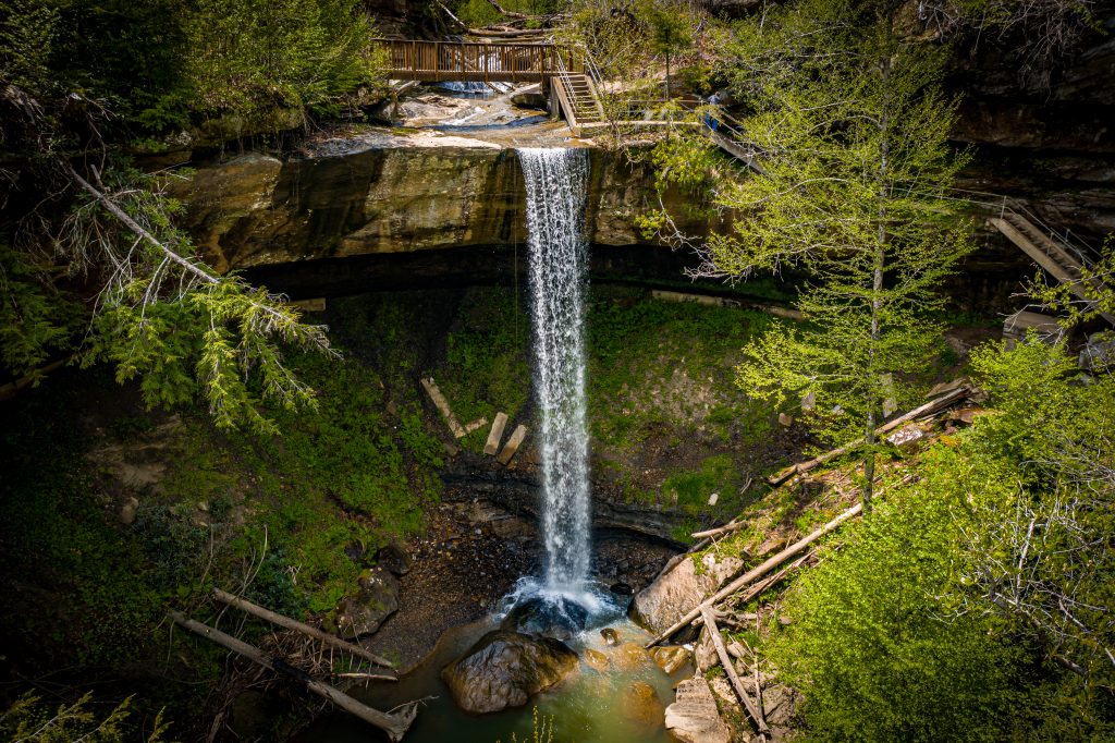 One of the beautiful waterfalls in Kentucky cascades down and hits the rocks below.