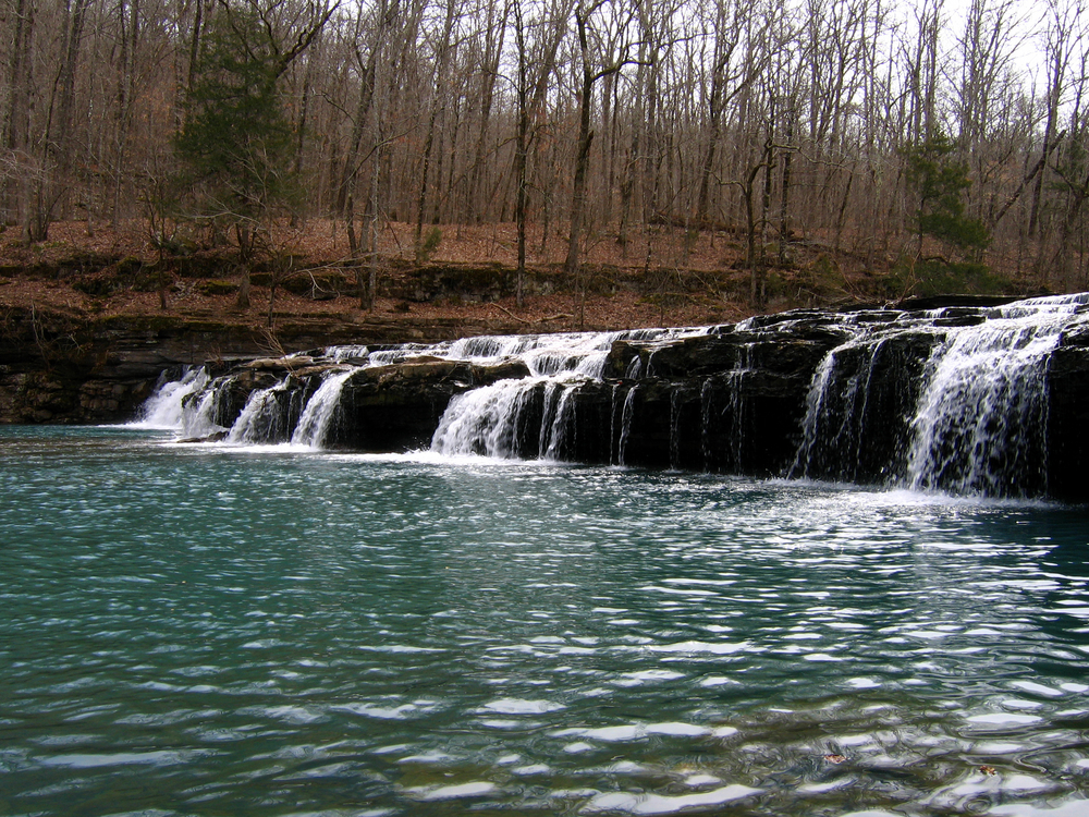 A photo of a waterfall cascading on Richland Creek Campground Trail, one of the best hikes Arkansas.