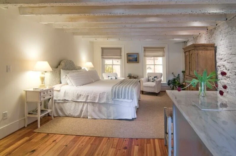 A  beautiful photo of a VRBO in Charleston with exposed white brick.