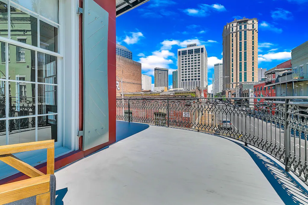 This trendy Warehouse District VRBO features a balcony with pristine views of New Orleans