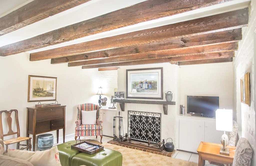 Photo of the living room with wooden beams at the Canterbury cottage, one of the most charming VRBO in Savannah