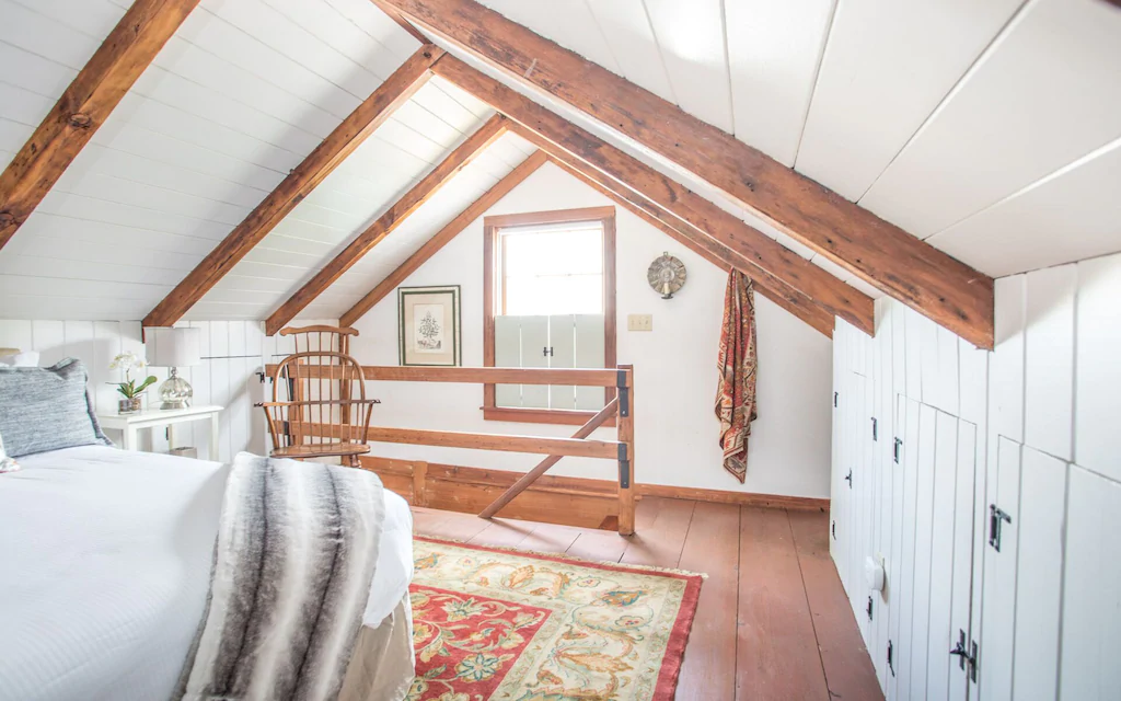 Photo of the upstairs bedroom with wooden beams at Freeman's cottage, one of the best VRBO in Savannah