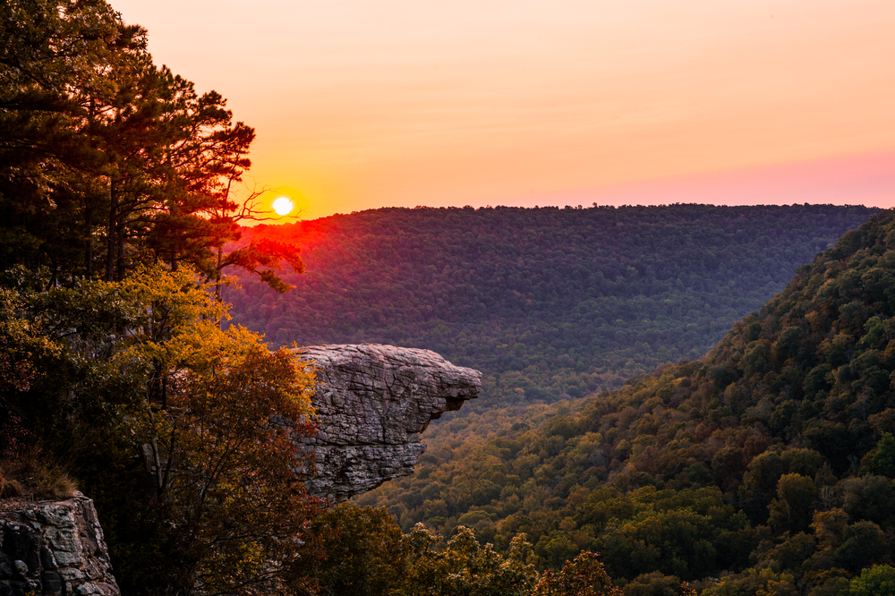 A photo of the massive view of Ozark National Forest and Hawksbill Crag at sunset, located on Whitaker Point Trail in Arkansas, one of the best trails in Arkansas.