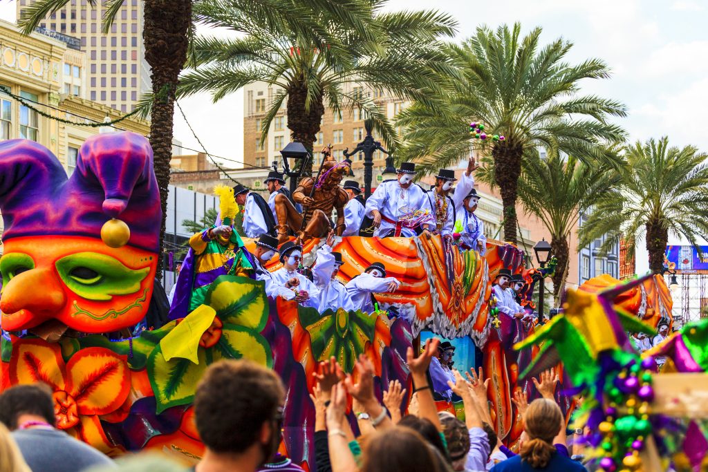 A parade during Mardi Gras, the best time to visit New Orleans