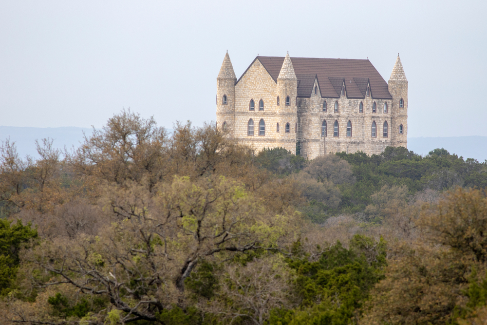 Photo of the Falkenstein Castle, towering over the acres of trees on its land. 