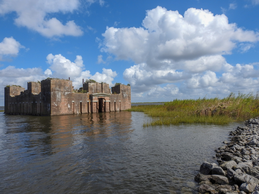 Photo of the weathered Fort Proctor partially submerged in Lake Borgne. 