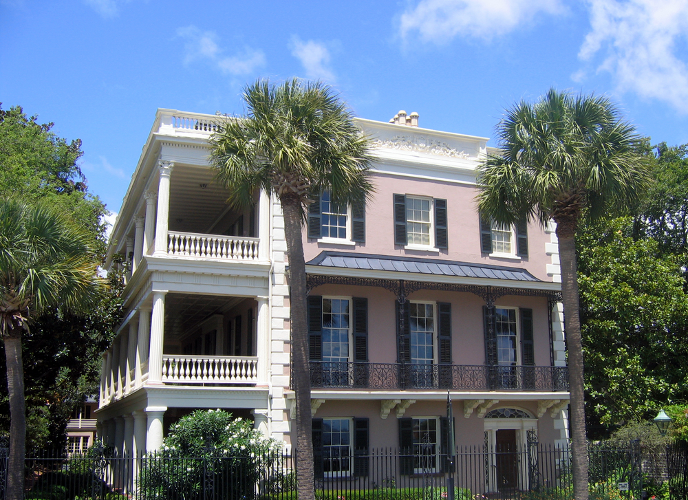 Exterior of the Edmondston-Alston House with palm trees and a balcony.