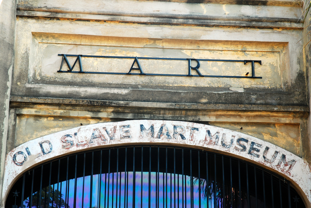 The entrance of the Old Slave Mart Museum. It is stone, with words painted on it that are fading. A great way to learn about a weekend in Charleston