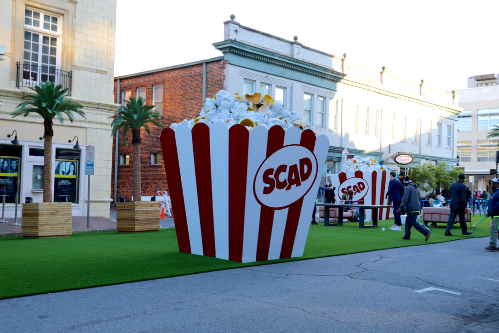 a giant popcorn container with buildings in the background at Savannah College of Art and Design. The scad shop is a great place for shopping in Savannah