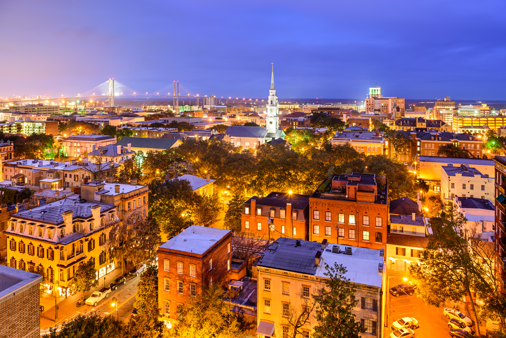 The dark lite skyline of Savannah with building and a church