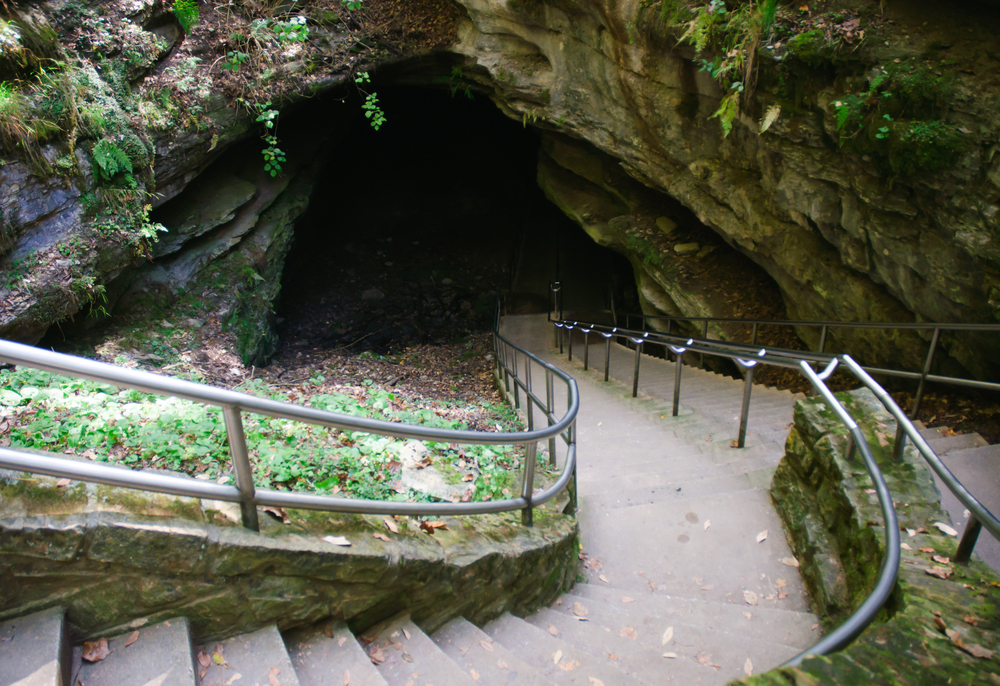 Photo of stairs leading down into a large cave at Mammoth Cave National Park, one of the best places for hiking in Kentucky,