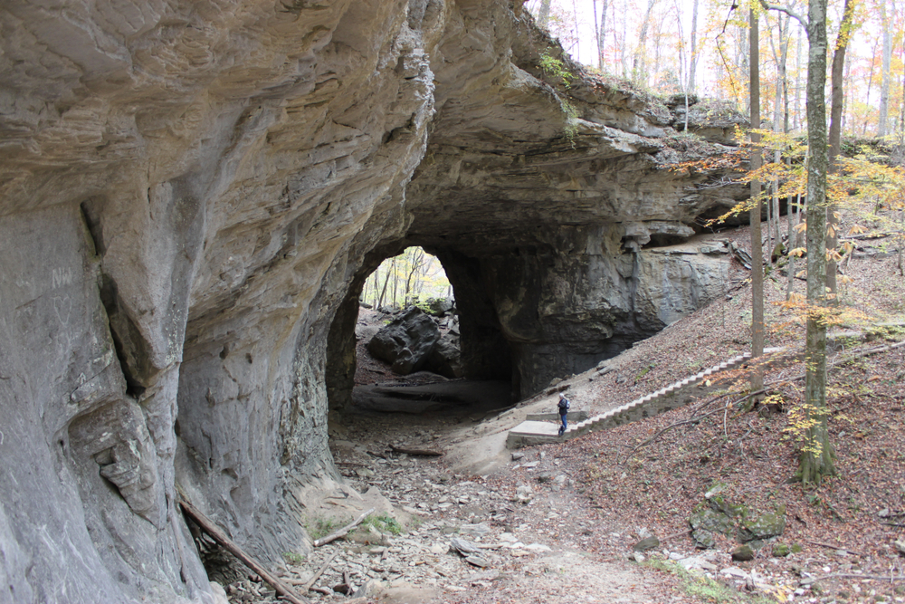 Photo of a trail leading underneath a natural rock arch, Smoky Bridge, at Carter Caves State Resort Park, 