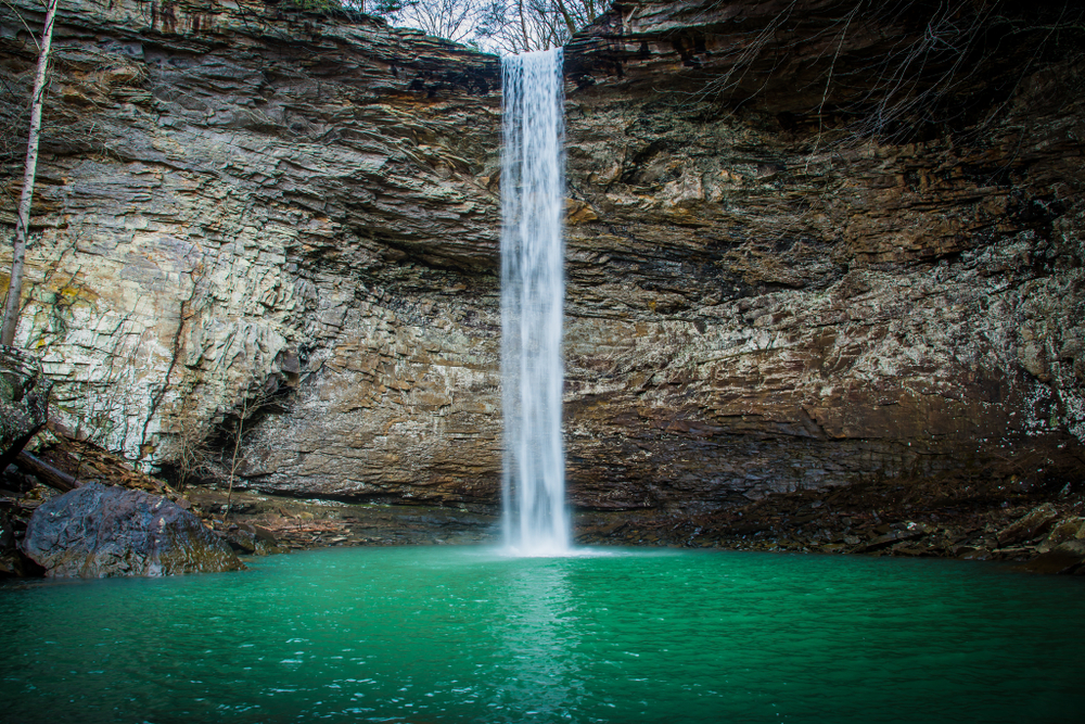 Photo of Ozone Falls plunging over a cliff into a bright blue pool