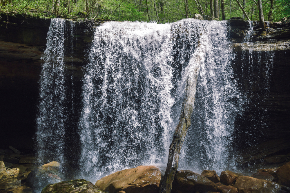 Photo of Virgin Falls, one of the best waterfalls in Tennessee, cascading over rocks into the ground below.