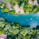 An aerial shot of the people tubing the crisp blue Guadalupe River that cuts through the center of a forest makes this one of the best weekend getaways from Dallas.