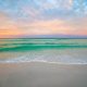 pristine beach in florida at sunset with blue water