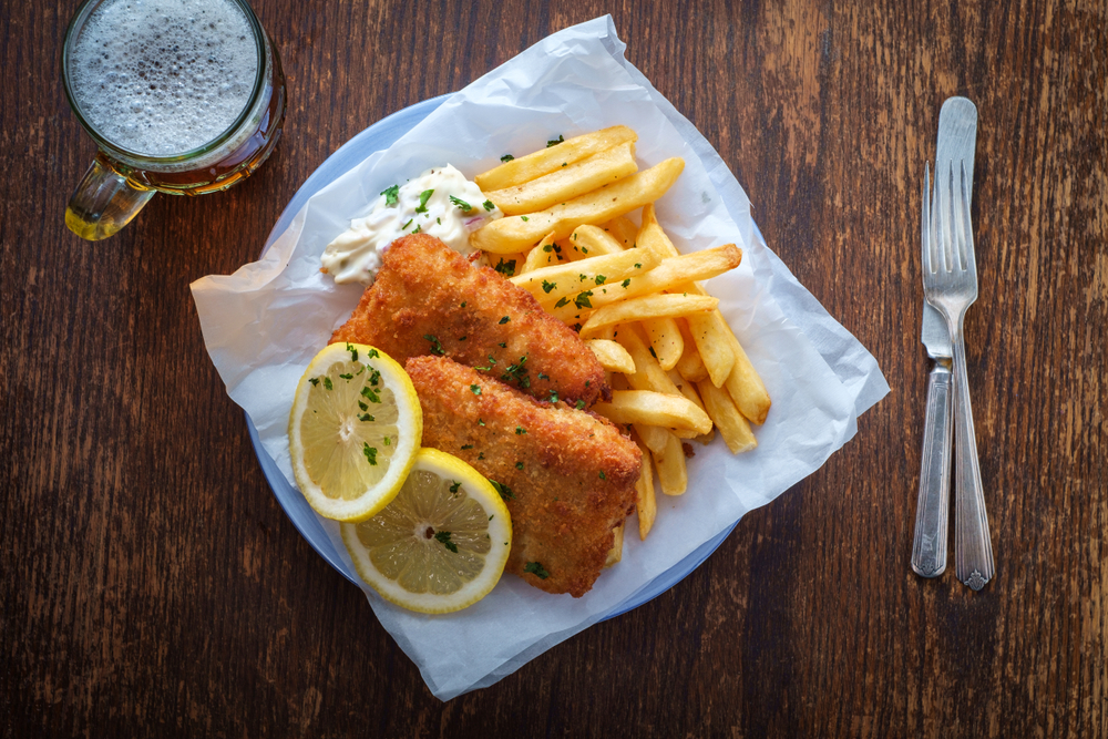 fried fish and french fries with tarter sauce and lemon wedge